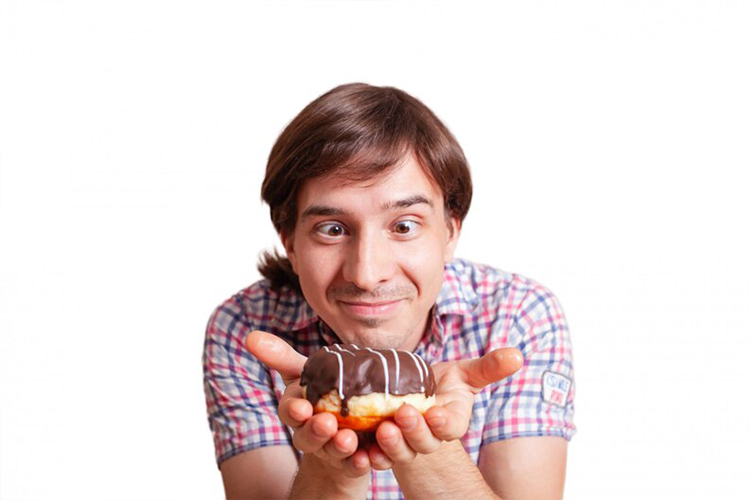 a man with an eager look at a cake